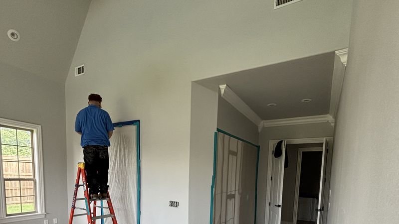 Drywall repair and repaint in progress with floors protected